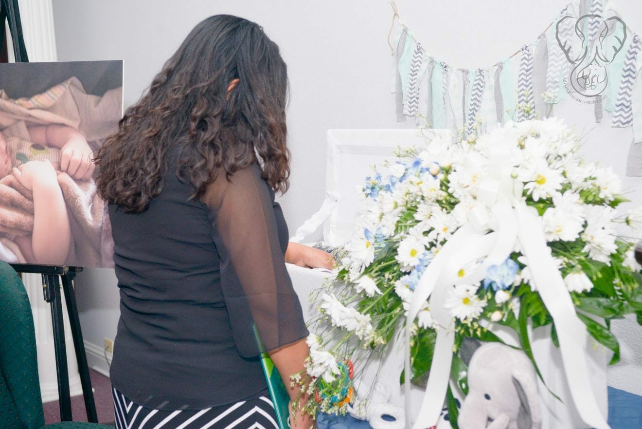 Miranda with Adrian's casket (Modern Lux Photography)