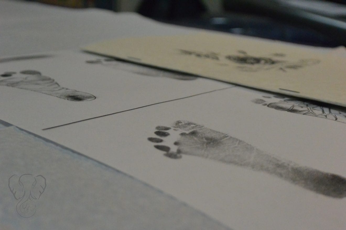 Close up of Adrian's footprints on a table. The footprints were used as templates to create the tattoo (Miranda Hernandez)